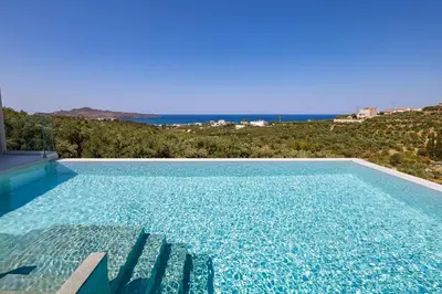 a swimming pool with a view of the ocean at Theo Luxury Villas With Sea View in Agia Marina Nea Kydonias