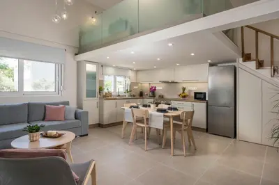 a kitchen and living room with a couch and a table at Eranthis Apartment in Chania Town