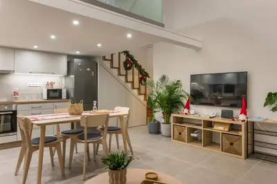 a kitchen with a table and chairs in a room at Eranthis Apartment in Chania Town