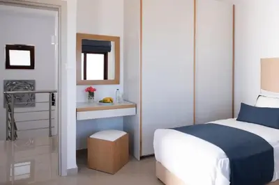 a bedroom with a bed and a sink and a mirror at Villa Alia in Sfakiá