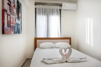 a bed with two towels in the shape of a heart at Newbulit Apartment 1km from the center of Chania in Chania Town