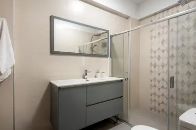 a bathroom with a sink and a mirror at Newbulit Apartment 1km from the center of Chania in Chania Town