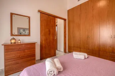 a bedroom with a bed and a dresser and a mirror at Lavande in Chania Town