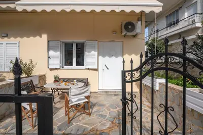 a patio with a table and chairs next to a house at Lavande in Chania Town