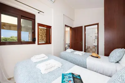 a room with two beds and a window at Villa Pasiphae 2 in Stalos