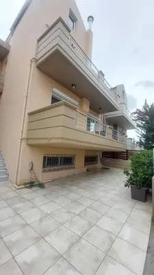 a large building with a balcony and a patio at Ammos Family Villa in Daratso