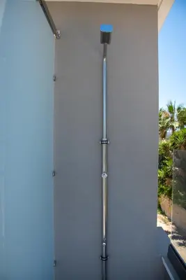 a shower in a bathroom with a wall at Casa Platanias Bridge in Plataniás