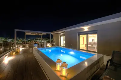 a swimming pool on the roof of a house at night at Casa Platanias Bridge in Plataniás