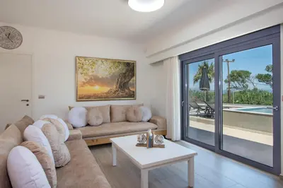 a living room with a couch and a table at Casa Platanias Bridge in Plataniás