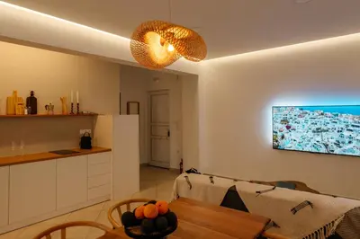 a living room with a table and a kitchen at El Chacha Apartment in Galatás