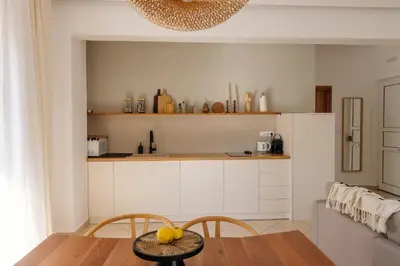 a kitchen with a table and chairs in a room at El Chacha Apartment in Galatás