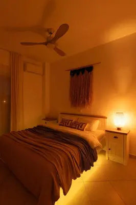 a bedroom with a bed and a ceiling fan at El Chacha Apartment in Galatás
