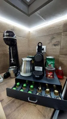 a kitchen counter with a coffee maker and cupcakes at Casa Manou - Kalyves beach in Kalyves