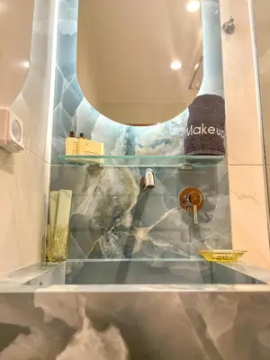 a glass shelf in a bathroom with a sink at Vista Mare apartments in Palaiochóra