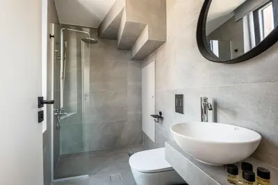 a bathroom with a sink and a toilet and a mirror at Amarillide rooms in Chania Town