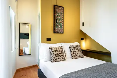 a bedroom with a bed and a mirror at Amarillide rooms in Chania Town