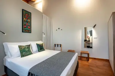 a bedroom with a large white bed in a room at Amarillide rooms in Chania Town