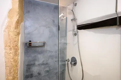 a shower with a glass door in a bathroom at Casa Elysium - Chania Old City in Chania Town