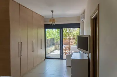 a room with a tv and a desk with a television at Maisonette with Exclusive Private Parking in Chania Town