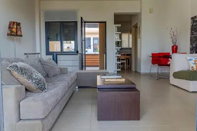 a living room with a couch and a coffee table at Maisonette with Exclusive Private Parking in Chania Town