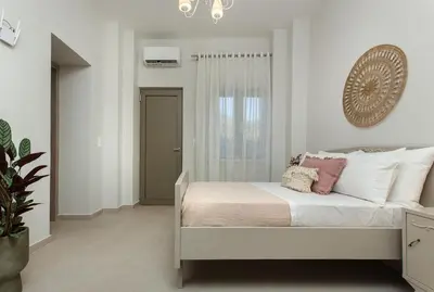 a bedroom with a bed with a clock on the wall at Villa Savina in Plátanos