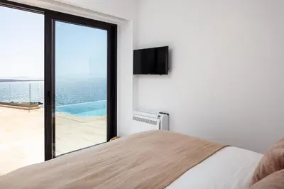 a bedroom with a bed and a view of the ocean at Casablanca Villa in Chania Town