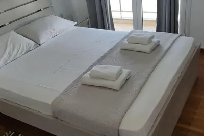a bed with two towels sitting on top of it at Charming Apartment In The Heart Of The City Chania in Chania Town