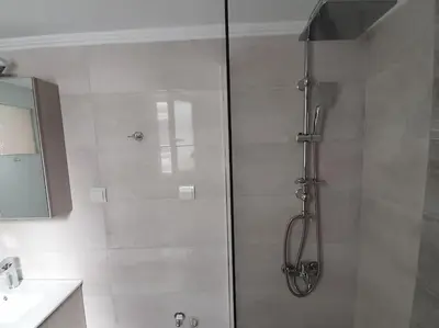 a shower with a glass door in a bathroom at Charming Apartment In The Heart Of The City Chania in Chania Town