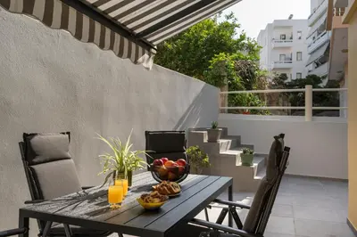 a table with a bowl of fruit on a balcony at Casa Amarillo - Halepa in Chania Town