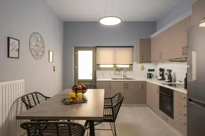 a kitchen and dining room with a table and chairs at Casa Amarillo - Halepa in Chania Town