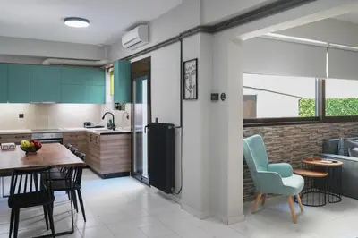 a kitchen with a table and chairs in a room at Dedalos City Apartment in Chania Town