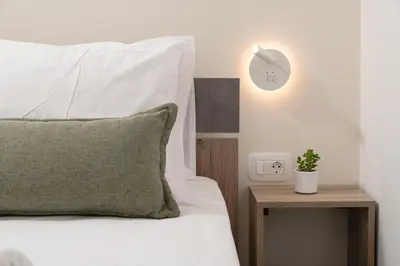a bedroom with a white bed with a plant on a table at Casa Makda in Parigoría