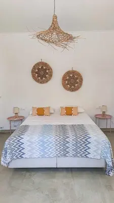 a bedroom with a large bed with two tables at Seamoon in Plataniás