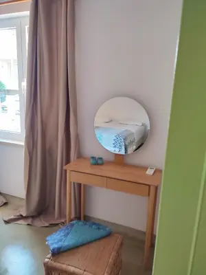 a mirror sitting on a wooden table next to a window at Seamoon in Plataniás