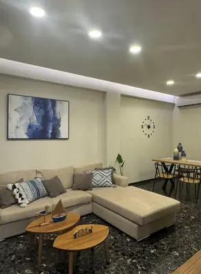a living room with a couch and two tables at Catherine Apartment in Chania Town