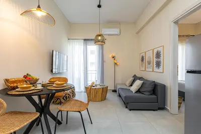 a living room with a couch and a table at Jo's Central & Cozy Apartment in Chania Town