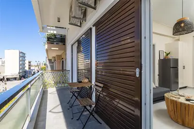 a balcony with a wooden wall and a table and chairs at Jo's Central & Cozy Apartment in Chania Town