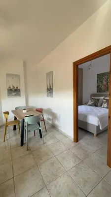 a bedroom with a bed and a table and a bed at Murele apartments in Daratso