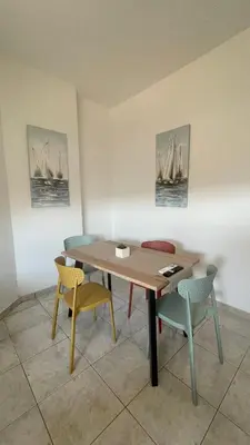 a dining room with a wooden table and chairs at Murele apartments in Daratso