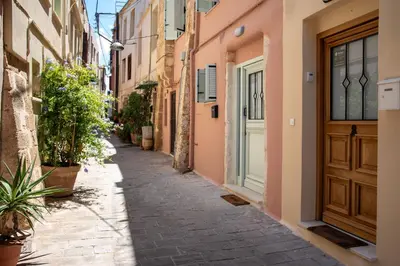 an alley in an old town with a wooden door at Casa Dione - Chania Old Town in Chania Town