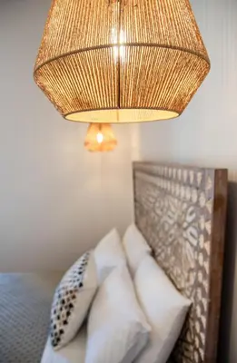 a chandelier hanging over a bed with pillows at Casa Dione - Chania Old Town in Chania Town