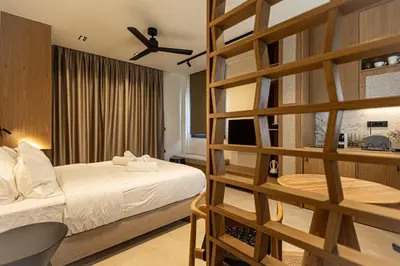 a hotel room with a bed and a book shelf at Aurora By Anasa in Palaiochóra