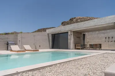 a swimming pool in front of a building at Alba Cave Villas in Chania Town