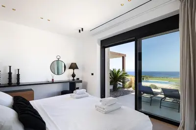 a bedroom with two beds and a view of the ocean at Kiyomi Villa in Chania Town