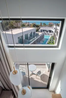 a view of the pool from the balcony of a house at Phos Hotel Adults Only in Plataniás