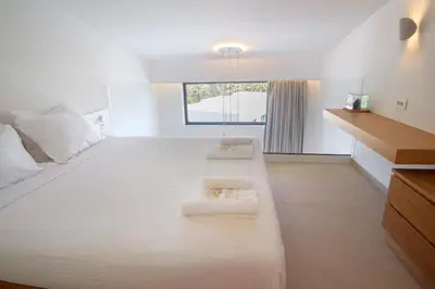 a large white room with two white benches in it at Phos Hotel Adults Only in Plataniás