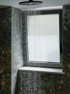 a shower with a window and a shower curtain at Casa in giardino in Chania Town