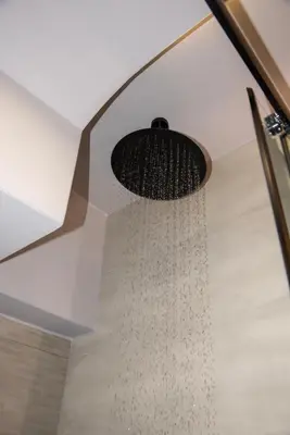 a shower with a trickle of water hanging from a ceiling at Cozy Rena luxury apartment with free private parking in Chania Town