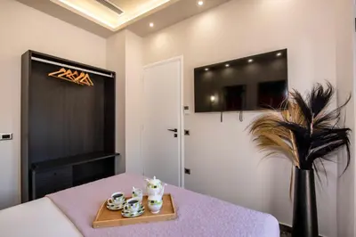 a room with a table with a tray of cups and a plant at Cozy Rena luxury apartment with free private parking in Chania Town
