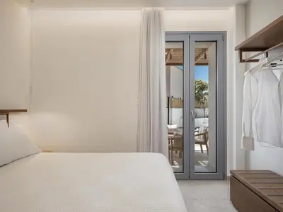 a bedroom with a bed and a sliding glass door at Villa Seyian in Chania Town